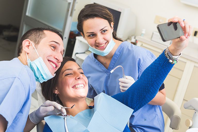 Patient taking a selfie with dentists